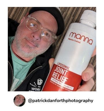 A manna customer holding up a bottle of Liposomal Joint Relief 3