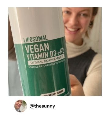 A manna customer holding up a bottle of Liposomal Vegan Vitamin D3+K2 4