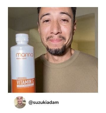 A manna customer holding up a bottle of Liposomal Vitamin C 2